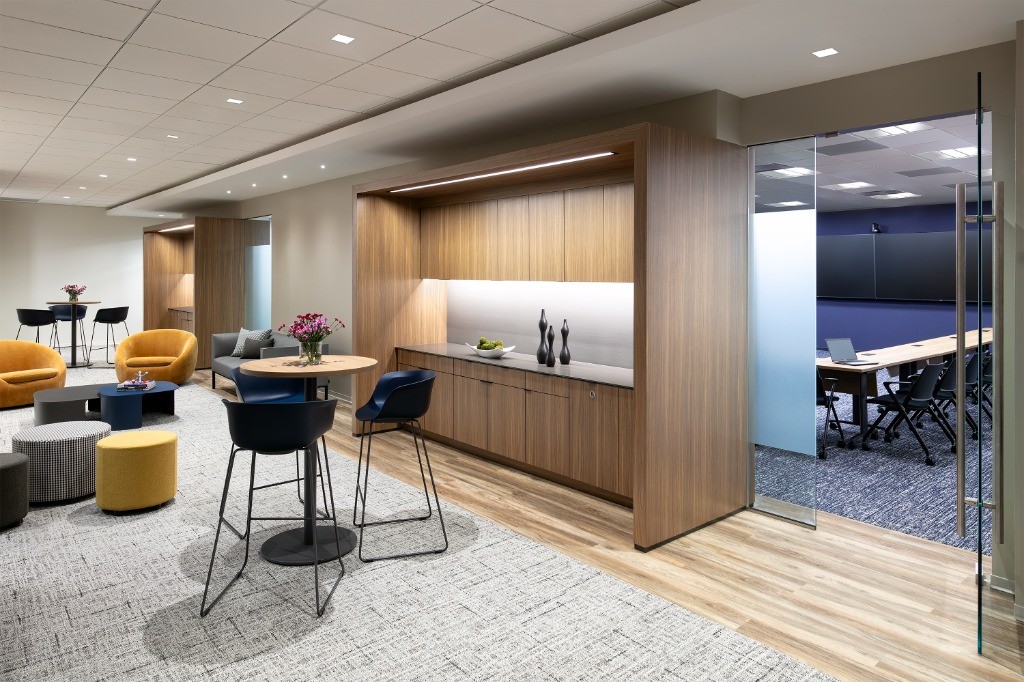 Modern corporate tenant amenity lounge and glass conference room buildout.